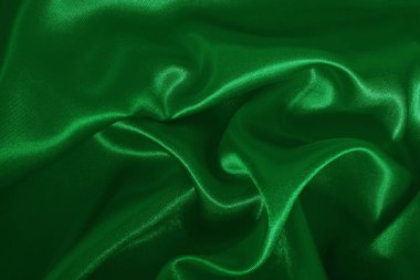 Yeşil zümrüt kumaş dokusu arkaplan, ipeğin veya keten deseninin ayrıntıları.