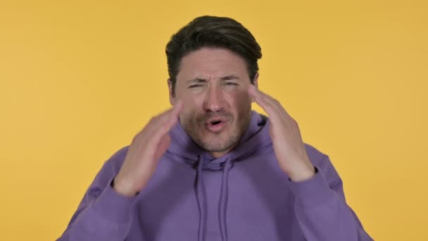 Young Man having Headache, Yellow Background — Stock Video