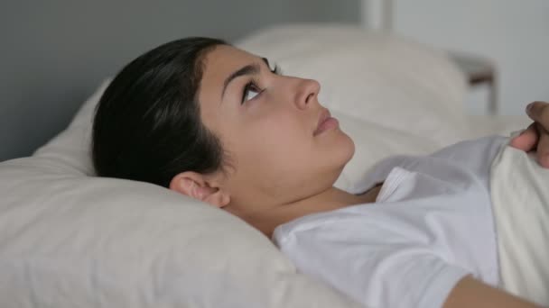 Jovem mulher indiana deitada acordada na cama — Vídeo de Stock