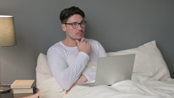 Pensive středověký muž s notebookem myšlení v posteli — Stock video