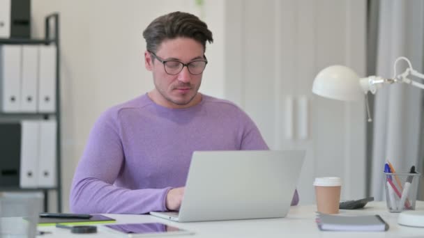 Hombre creativo de mediana edad con computadora portátil celebrando en la oficina — Vídeo de stock