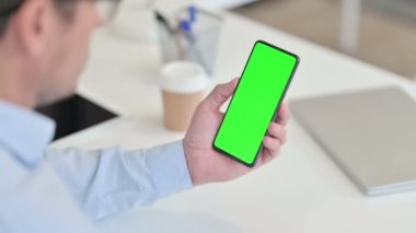 Arka Görünüm Orta Çağ Adamı Krom Ekran ile Akıllı Telefon Kullanıyor 