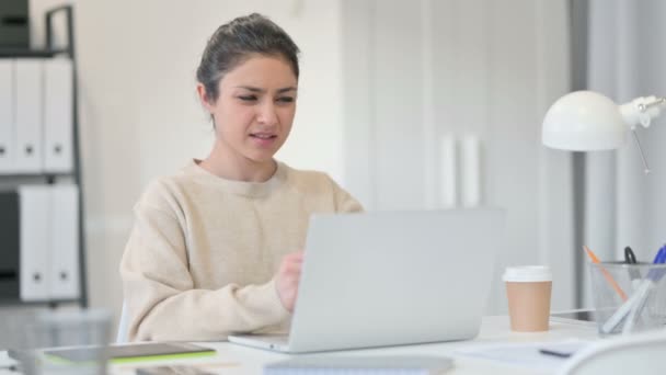 Kreative Inderin mit Laptop mit Handgelenkschmerzen — Stockvideo