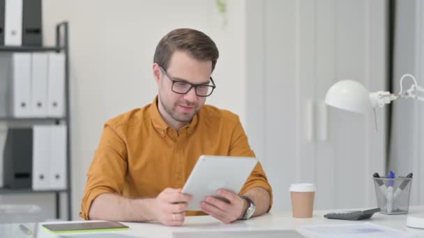 Young Man Celebrating Success on Tablet — Stock Video