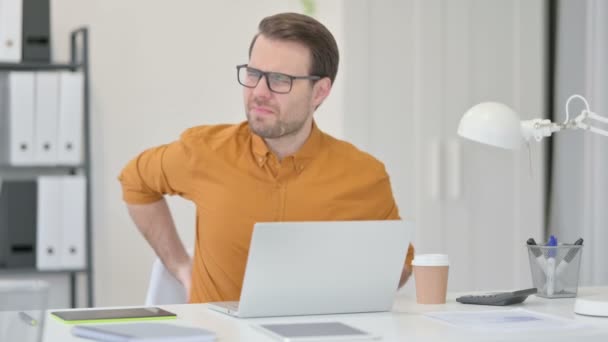 Young Man with Laptop having Back Pain in Office — Stock Video