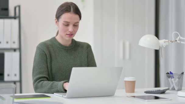 Jonge vrouw met laptop viert succes — Stockvideo