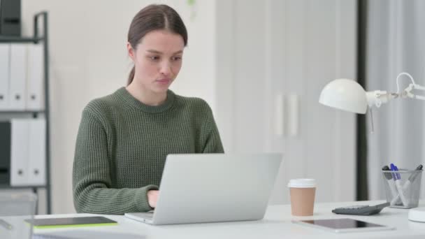 Young Woman with Laptop Stretching in Office — Stock Video