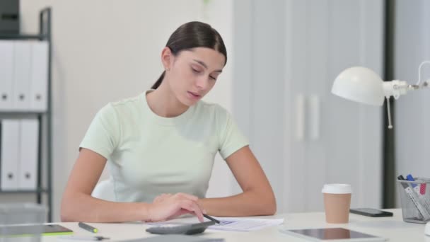 Женщина с помощью калькулятора для работы с документами — стоковое видео