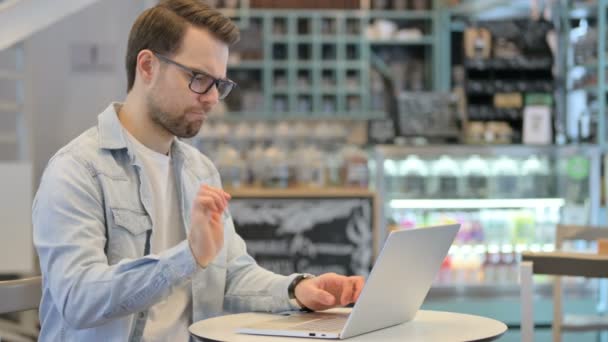 Kreativer Mann mit Handgelenkschmerzen bei der Arbeit am Laptop — Stockvideo