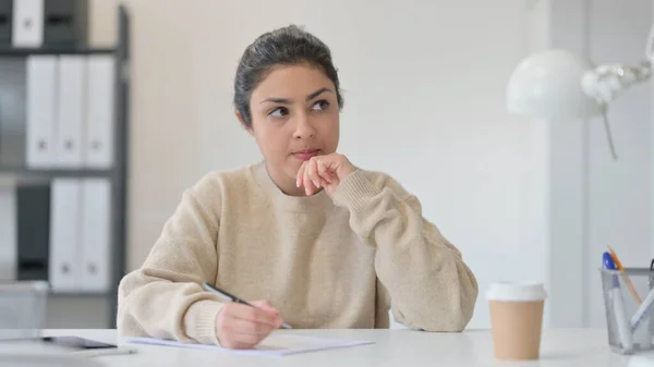 Mujer india joven pensativa escribiendo en papel —  Fotos de Stock