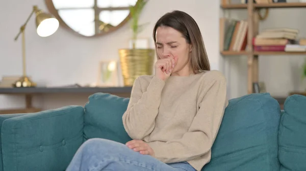 Sick Young Woman Coughing on Sofa