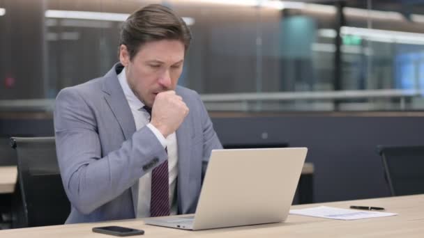 Middle Aged Businessman with Laptop Coughing in Office — Stock Video