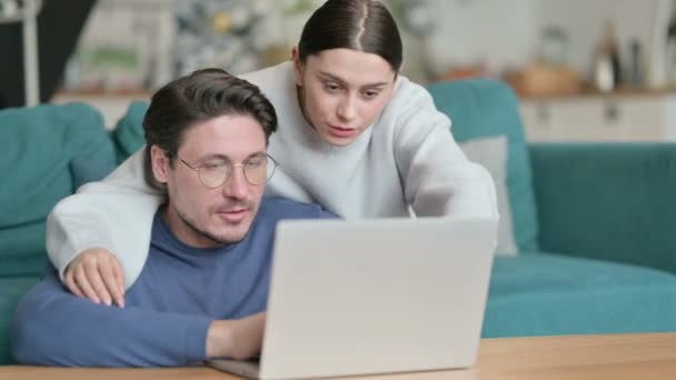 Couple latin célébrer le succès tout en utilisant ordinateur portable ensemble à la maison — Video