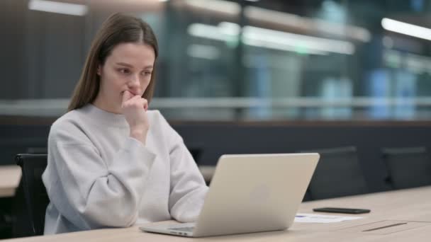 Femme pensant tout en utilisant un ordinateur portable au travail — Video