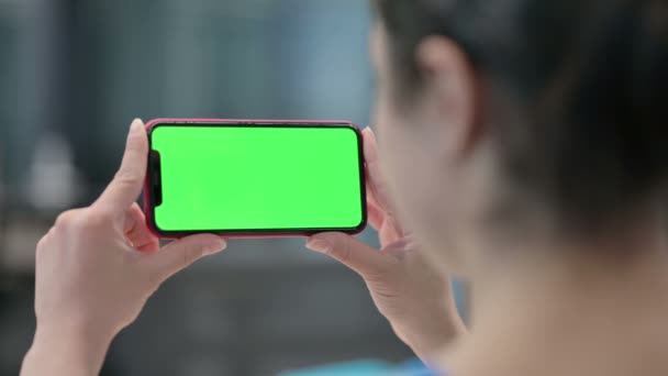 Индийская женщина смотрит на смартфон с цветным экраном — стоковое видео