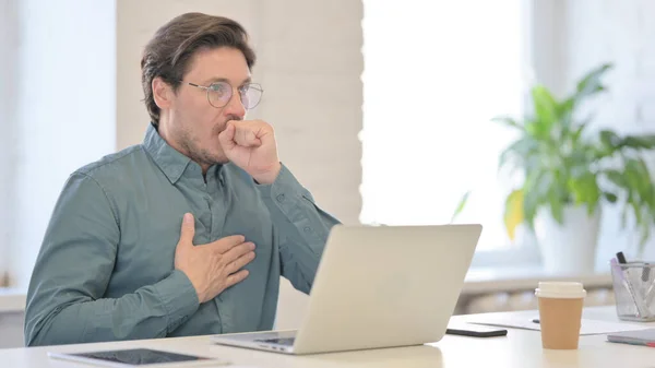 Middle Aged Man with Laptop having Coughing