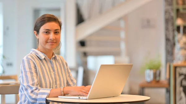 Szakmai Indian Woman with Laptop Looking at Camera in Cafe — Stock Fotó