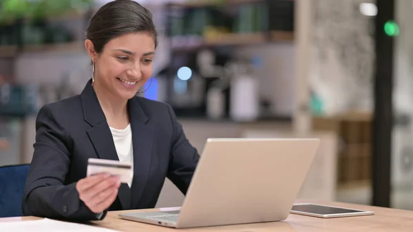 Індійська ділова жінка робить успішний онлайн платежі на Laptop в офісі — стокове фото