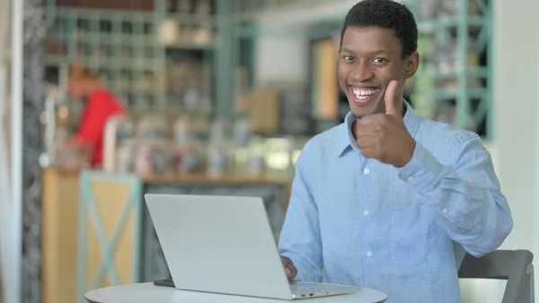 Thumbs Up by Young African Man working in Cafe — Stock Photo, Image