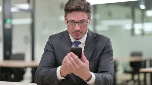 Retrato de hombre de negocios de mediana edad utilizando Smartphone — Foto de Stock