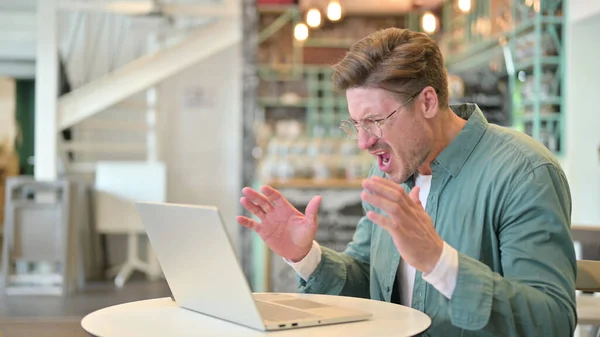 Loss, Middle Aged Man reacting to Failure on Laptop in Cafe — Stock Photo, Image