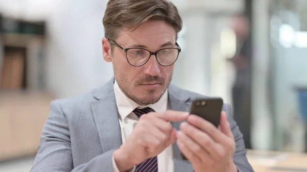 Porträt eines Geschäftsmannes mit Smartphone — Stockfoto