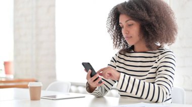 Akıllı telefon kullanan Ciddi Afrikalı Kadın 