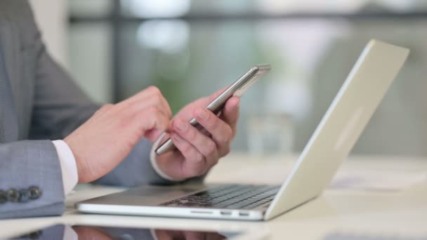 Close Up of Businessman using Smartphone, near Laptop — Stock Video