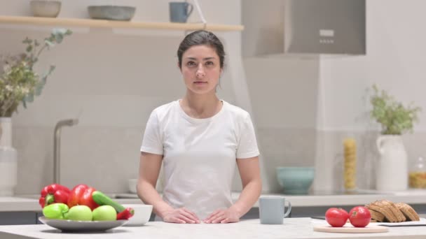 Indiano donna guardando il fotocamera mentre in piedi in cucina — Video Stock