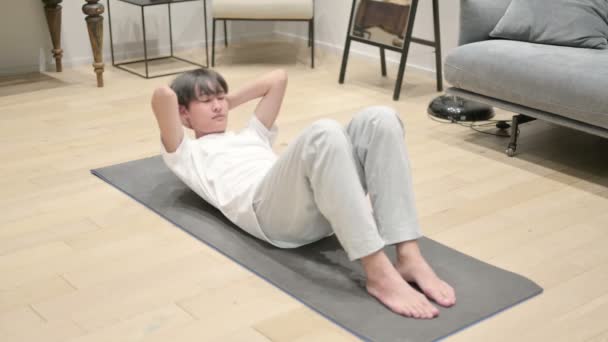 Asian Man doing Workout on Yoga Mat at at Home — стоковое видео