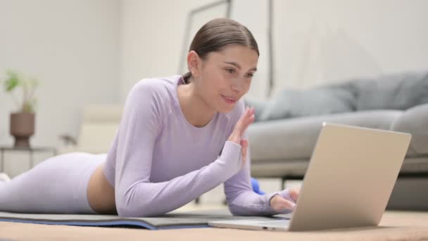 Latin Woman talar på video Ring på laptop på Yogamattan — Stockvideo