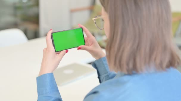 Mujer joven mirando Smartphone con pantalla de croma — Vídeo de stock