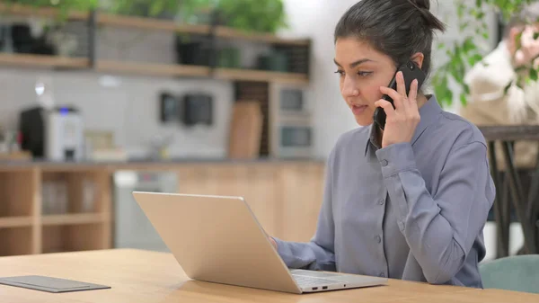 Indian Woman with Laptop Talking on Phone