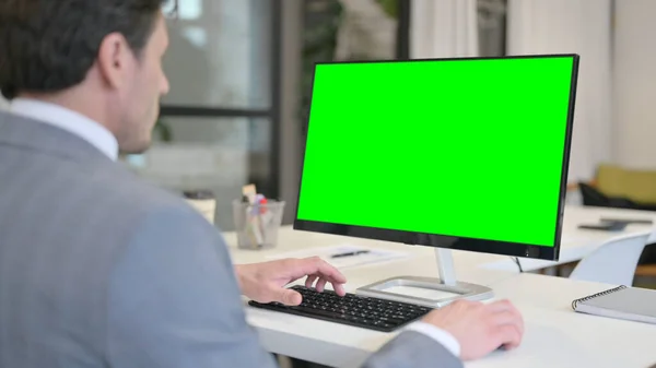 Businessman using Desktop with Green Chroma Key Screen