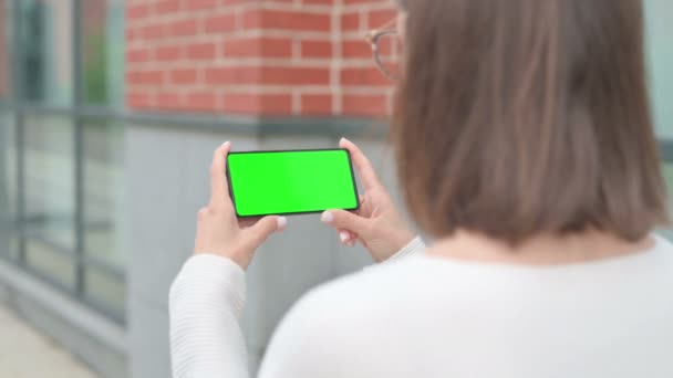 Mujer al aire libre usando Smartphone con pantalla de croma verde — Vídeos de Stock