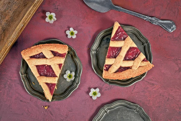 Slices of pie called \'Linzer Torte\', a traditional Austrian shortcake pastry topped with fruit preserves and sliced nuts with lattice design
