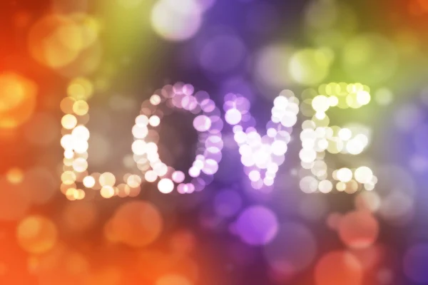Amor inscripción con luces desenfocadas en boke colorido abstracto — Foto de Stock
