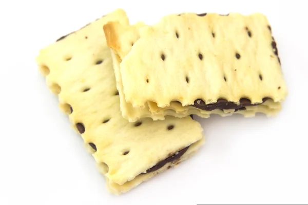 Biscuits with chocolate cream filling on white background — Stock Photo, Image