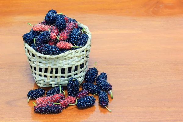 Mulberry in basket on wooden background — Stock Photo, Image