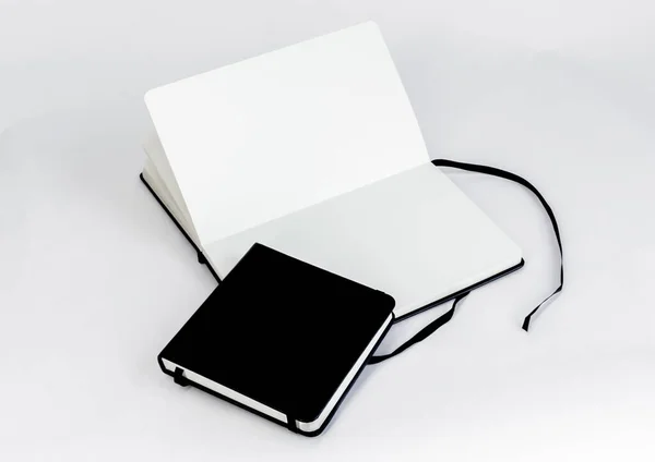 Two Black Notebooks Small Closed Square Notepad Large Open Unfold — Stock Photo, Image