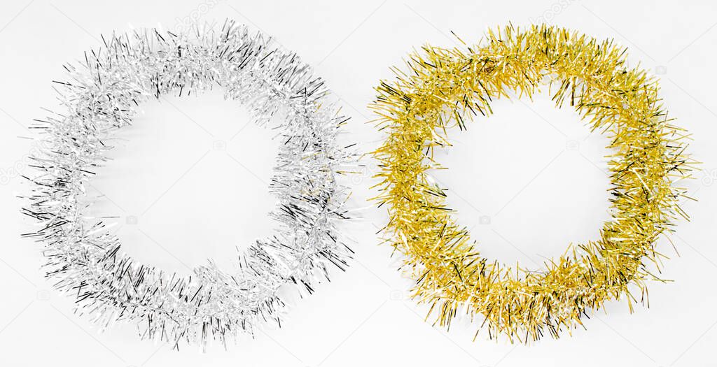 Round circles of silver and golden tinsel. New year decorations on a white background. Christmas concept for text