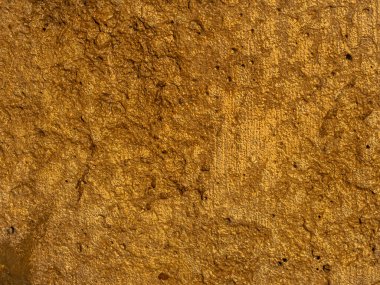 Güzel Altın desenli kaba yaprak folyo arka plan. Parlak, koyu sarı, soyut desenli altın taş. Lekeler ve rahatlama