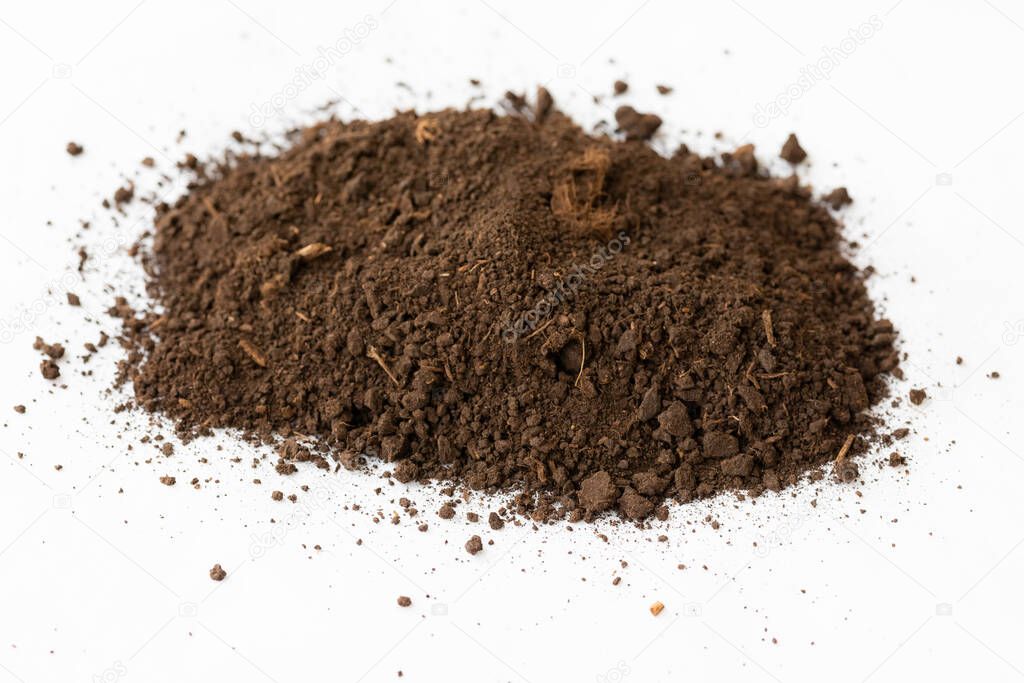 A pile of black dark brown peat, a natural fertilizer formed from particles of dead bog plants. Loose sedimentary rock that is used as a combustible mineral on a white background
