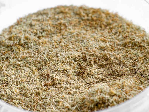 Dry sphagnum, peat moss, perennial marsh white moss of light brown beige yellow color in a transparent large round bucket close-up on white background