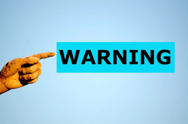 Finger with rectangular light blue label WARNING — Stock Photo, Image