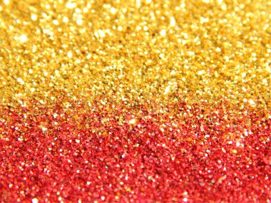 Blurry background of golden and red glitter sparkle clipart