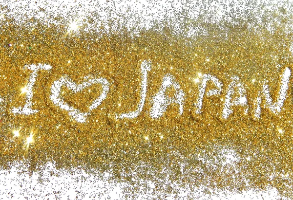 Nápis love Japonsko na zlaté třpytky jiskří na bílém pozadí — Stock fotografie