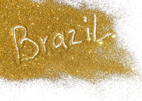 Blurry inscription Brazil on golden glitter sparkles on white background