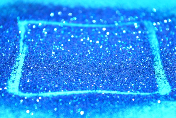 Sfondo astratto sfocato con cornice rettangolare di brillantini blu scintilla sulla superficie blu — Foto Stock