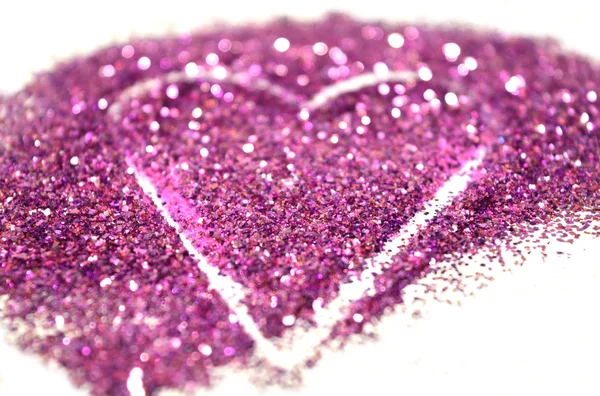 Blurry abstract background with heart of purple glitter sparkle on white surface — Stock Photo, Image